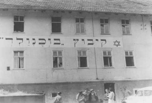 Jewish refugees in front of the "Kibbutz Buchenwald" building, where Jews received agricultural training in preparation for life ...