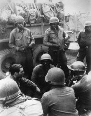 Members of the 12th Armored Division, which included African American platoons, await their orders. [LCID: 83791]